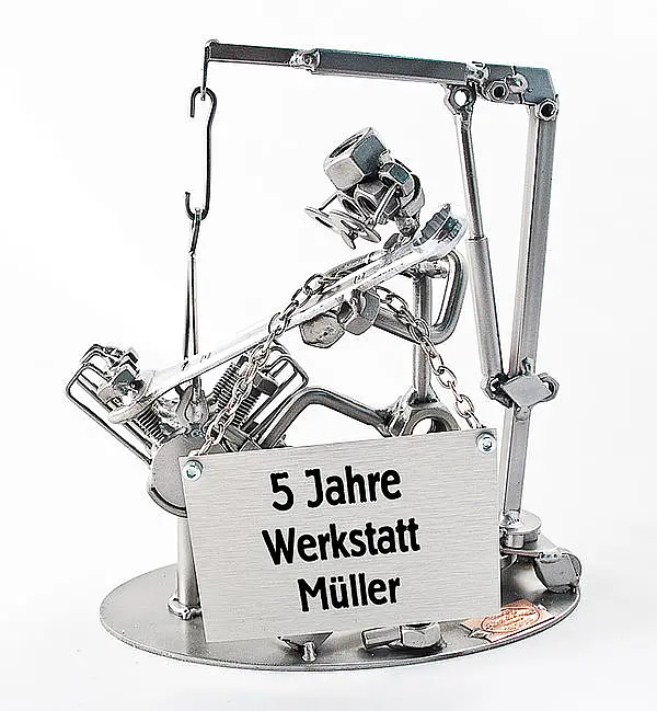 Schraubenmännchen Motortechniker mit Schild