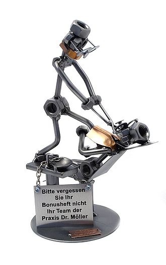 Schraubenmännchen Kieferorthopäde mit Schild Schraubenmännchen Kieferorthopäde mit Schild